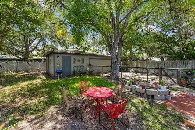 4009 Pope Dr, Corpus Christi, TX 78411 - fenced backyard featuring an outdoor living space, a patio area, a garage, and an outdoor structure