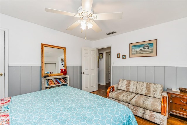 4009 Pope Dr, Corpus Christi, TX 78411 - bedroom with dark wood-style floors, a wainscoted wall, and ceiling fan