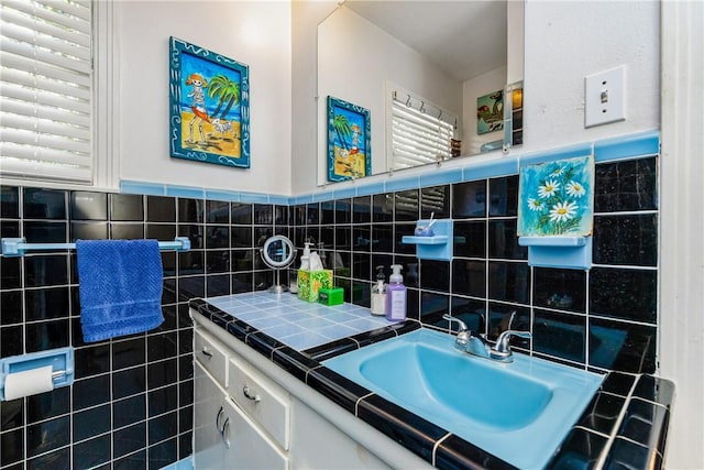 4009 Pope Dr, Corpus Christi, TX 78411 - bathroom featuring vanity, tile walls, and a wainscoted wall