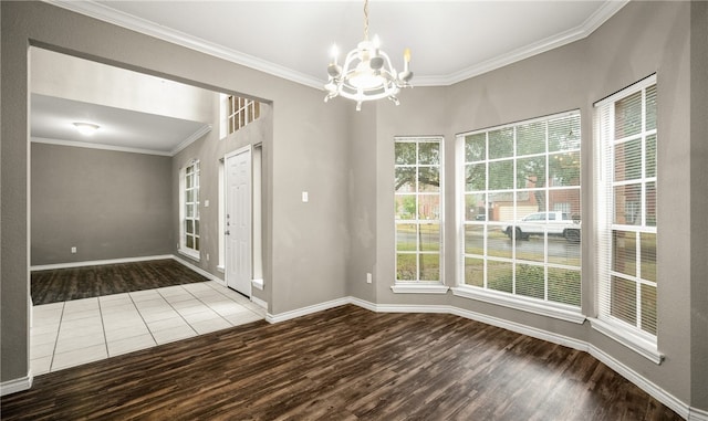 interior space featuring hardwood / wood-style flooring, crown molding, and an inviting chandelier