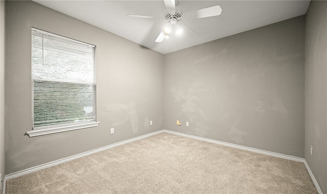 empty room featuring carpet floors and ceiling fan