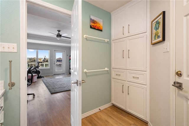 hall with baseboards and light wood-style floors