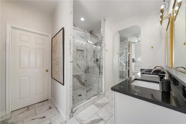 full bath with vanity, a marble finish shower, recessed lighting, baseboards, and marble finish floor