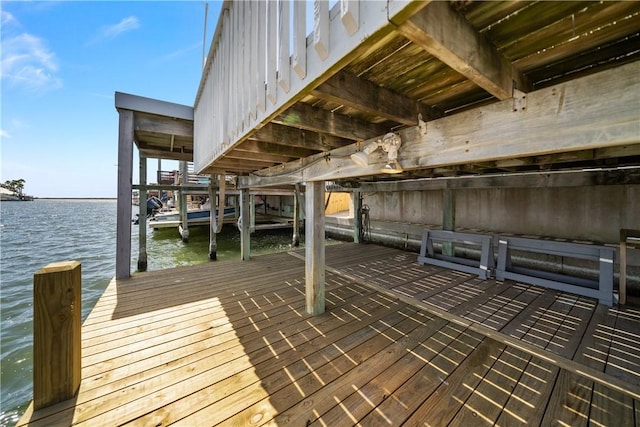 dock area with boat lift and a water view