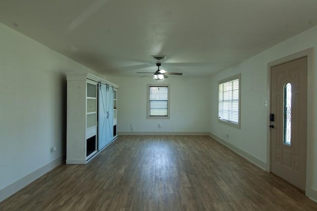 315 W Greenwood Ave, Aransas Pass, TX 78336 - interior space with ceiling fan, dark wood finished floors, and a barn door