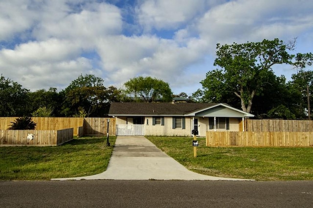 315 W Greenwood Ave, Aransas Pass, TX 78336 - view of front of house featuring a fenced front yard, a front yard, a gate, and concrete driveway