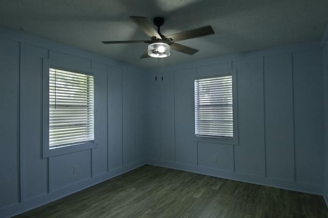 315 W Greenwood Ave, Aransas Pass, TX 78336 - empty room with a textured ceiling, a decorative wall, wood finished floors, and a ceiling fan