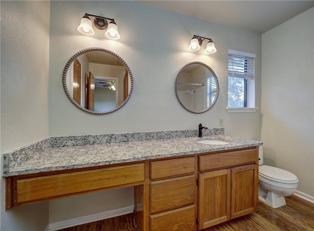 7140 Premont Dr Unit 12, Corpus Christi, TX 78414 - bathroom with wood finished floors, toilet, vanity, baseboards, and a shower