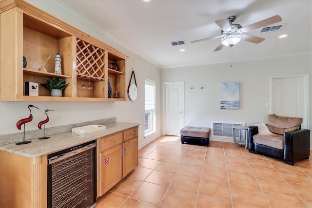 kitchen with light stone countertops, ceiling fan, wine cooler, crown molding, and light tile patterned flooring