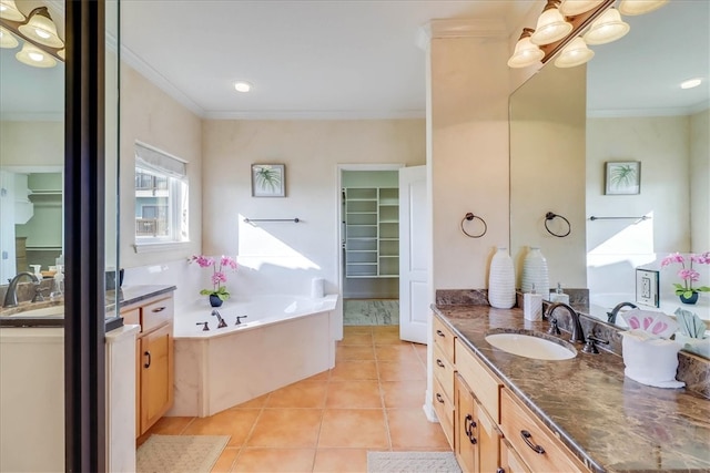 bathroom featuring tile patterned flooring, vanity, a bathing tub, and crown molding