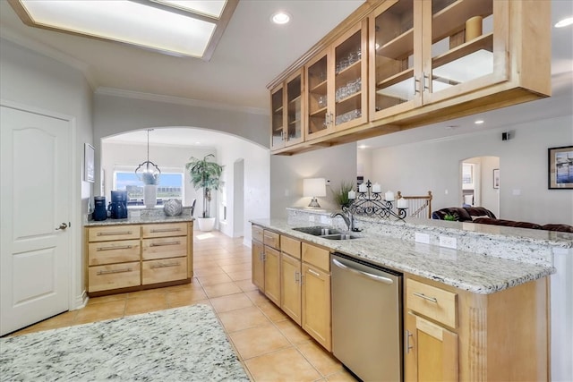 kitchen featuring pendant lighting, sink, stainless steel dishwasher, light stone countertops, and light tile patterned floors