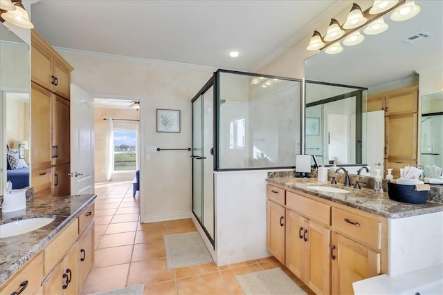 bathroom with tile patterned floors, ceiling fan, crown molding, and a shower with shower door