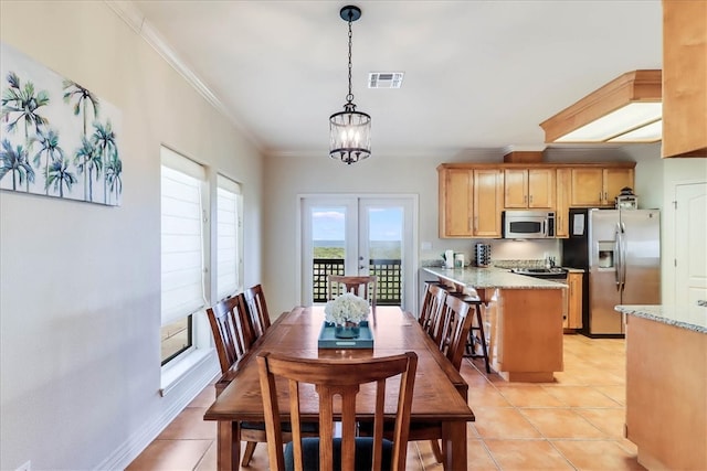 tiled dining room featuring a notable chandelier, crown molding, and french doors