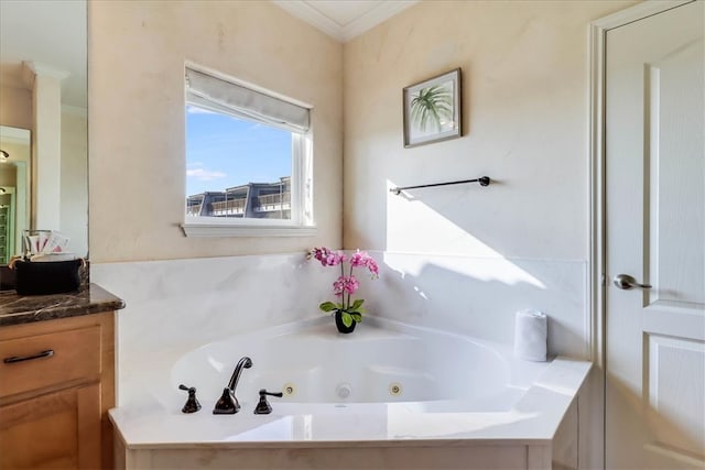 bathroom featuring a tub, vanity, and ornamental molding