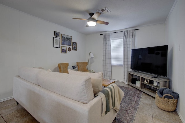 tiled living room featuring ceiling fan