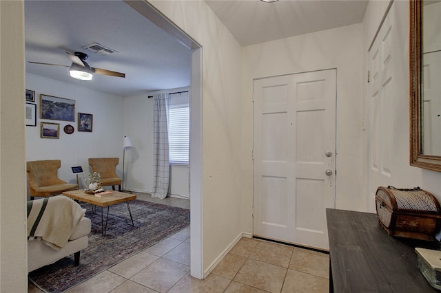 tiled foyer entrance with ceiling fan