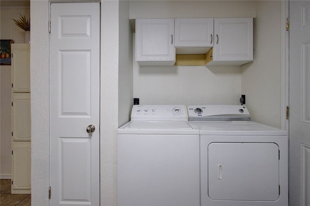 washroom featuring cabinets, separate washer and dryer, and tile patterned flooring