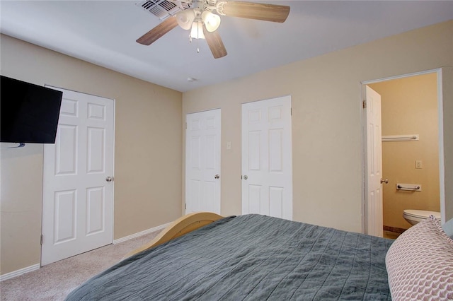 bedroom featuring carpet floors, ceiling fan, and ensuite bathroom