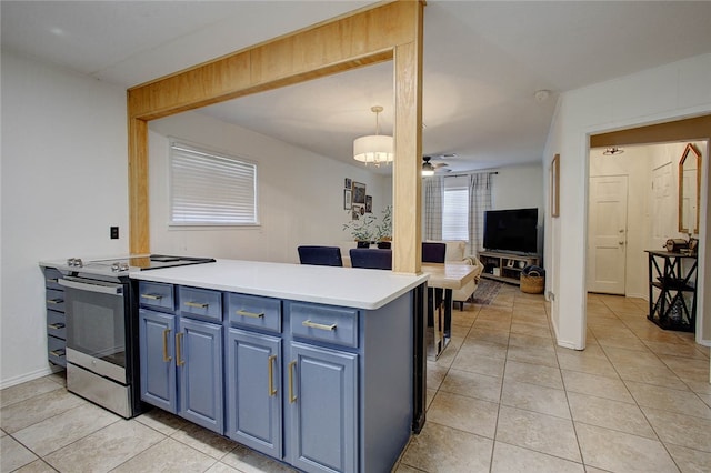 kitchen featuring ceiling fan, light tile patterned floors, stainless steel range with electric cooktop, blue cabinets, and pendant lighting