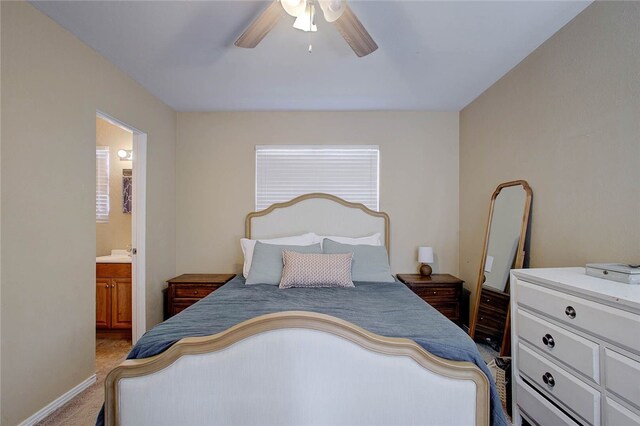 bedroom featuring ensuite bathroom, ceiling fan, and carpet flooring