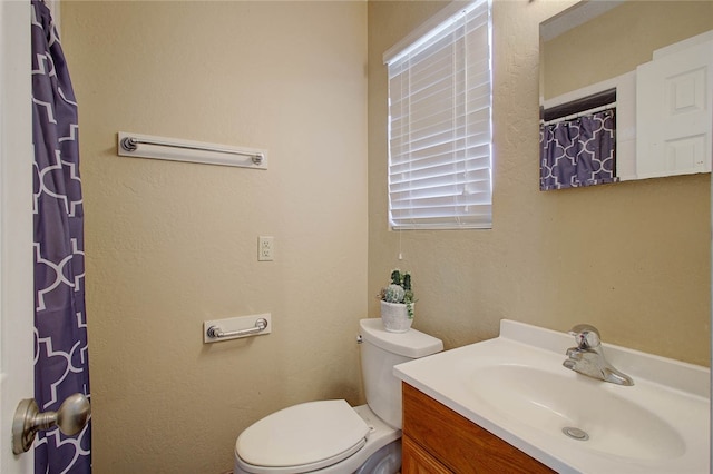 bathroom featuring toilet and vanity