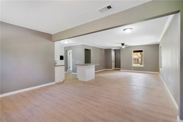 2121 Cedar St, Paris, TX 75460 - unfurnished living room featuring ornamental molding, a ceiling fan, and light wood-type flooring