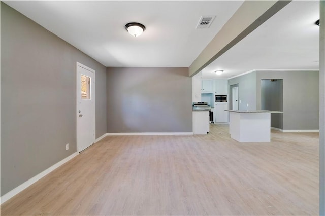 2121 Cedar St, Paris, TX 75460 - unfurnished living room featuring light wood-type flooring and baseboards