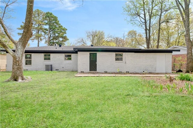 2121 Cedar St, Paris, TX 75460 - rear view of house featuring brick siding and a yard
