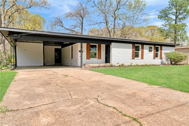 2121 Cedar St, Paris, TX 75460 - mid-century inspired home with concrete driveway, a front lawn, an attached carport, and brick siding