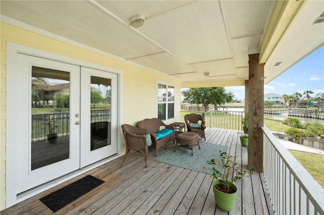 219 Pintail Ln, Rockport, TX 78382 - wooden terrace with a water view and french doors