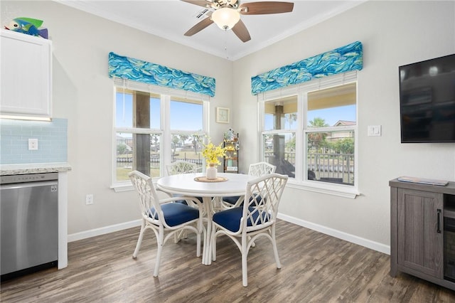 219 Pintail Ln, Rockport, TX 78382 - dining room featuring ceiling fan, dark wood-style flooring, baseboards, crown molding, and healthy amount of natural light