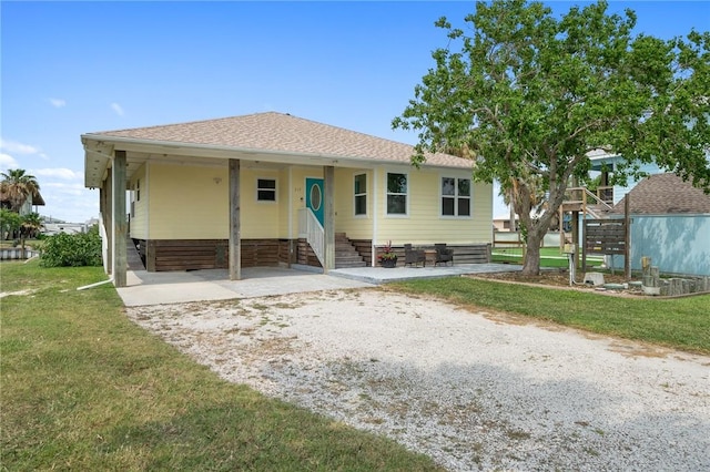 219 Pintail Ln, Rockport, TX 78382 - view of front of house featuring stairs, a front yard, and entry steps