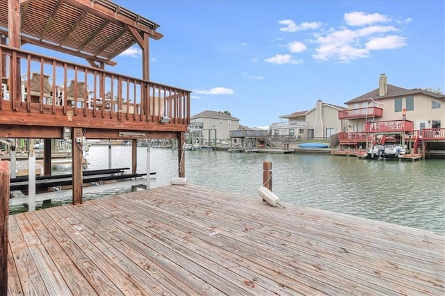 dock area featuring a water view, a residential view, and boat lift