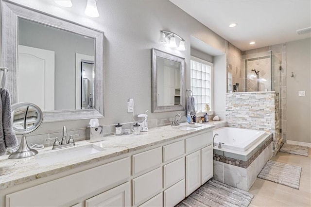 full bath with a garden tub, double vanity, a tile shower, and a sink