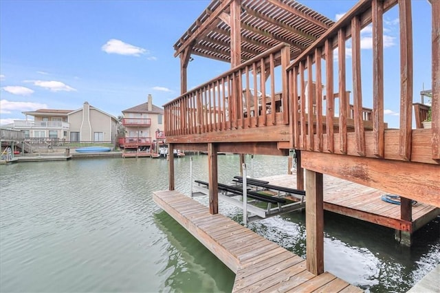 dock area featuring boat lift and a water view