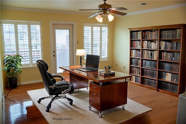 home office with baseboards, wood finished floors, a ceiling fan, and ornamental molding