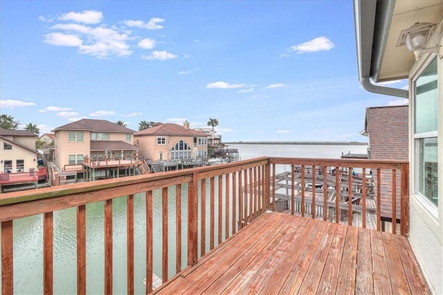 deck with a residential view and a water view