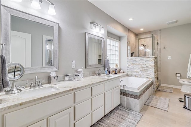 bathroom with a sink, visible vents, a stall shower, and a bath