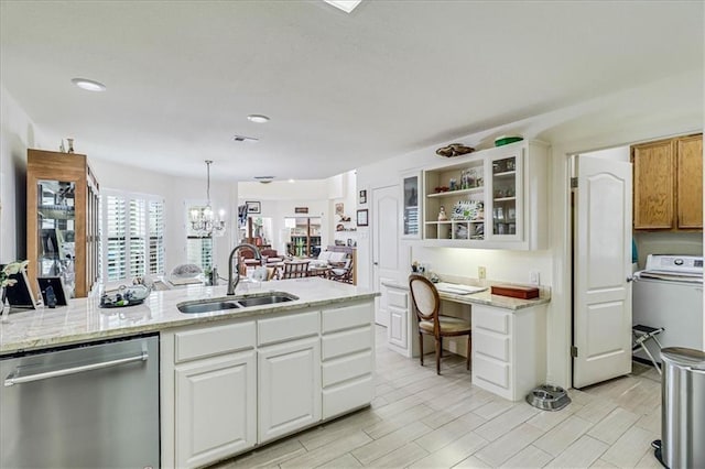 kitchen featuring washer / dryer, a sink, white cabinets, glass insert cabinets, and stainless steel dishwasher