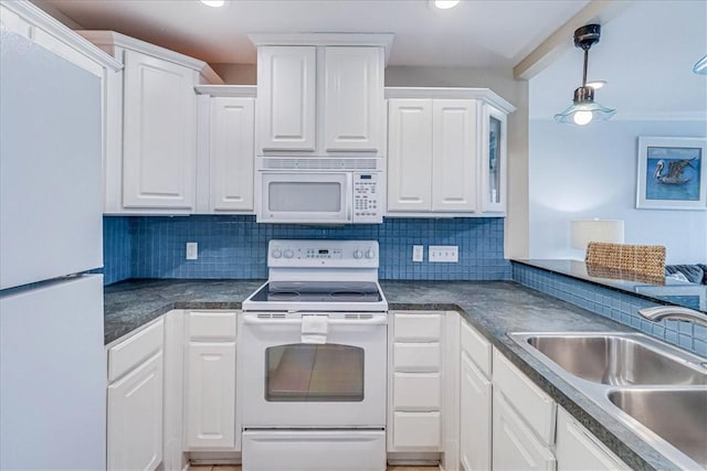 kitchen with white appliances, a sink, white cabinetry, and tasteful backsplash