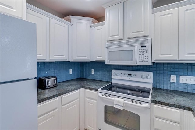 kitchen featuring dark countertops, white appliances, white cabinetry, and decorative backsplash