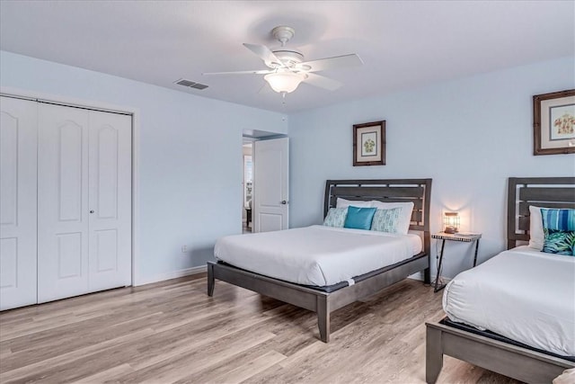 bedroom with visible vents, baseboards, a ceiling fan, a closet, and light wood-type flooring