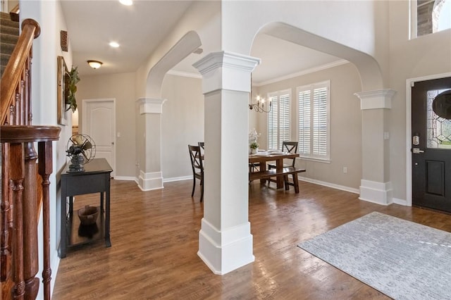 6105 Greenough Ct, Corpus Christi, TX 78414 - foyer featuring arched walkways, decorative columns, dark wood-style floors, stairs, and a chandelier