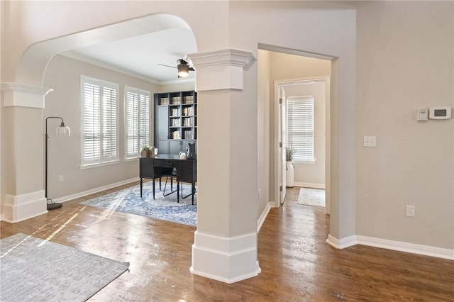 6105 Greenough Ct, Corpus Christi, TX 78414 - hallway featuring arched walkways, ornate columns, crown molding, wood finished floors, and a desk