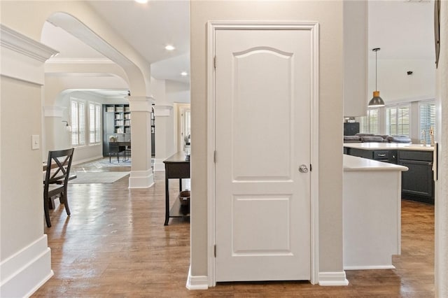 6105 Greenough Ct, Corpus Christi, TX 78414 - hallway with arched walkways, decorative columns, wood finished floors, ornamental molding, and recessed lighting