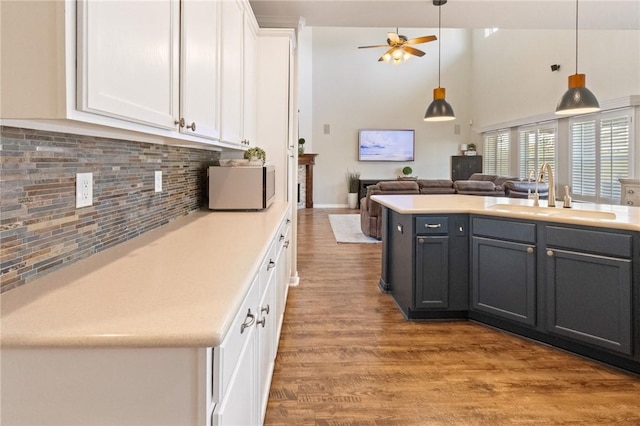 6105 Greenough Ct, Corpus Christi, TX 78414 - kitchen with white cabinets, open floor plan, light countertops, wood finished floors, and pendant lighting