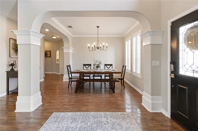 6105 Greenough Ct, Corpus Christi, TX 78414 - dining area featuring arched walkways, dark wood finished floors, crown molding, and a chandelier