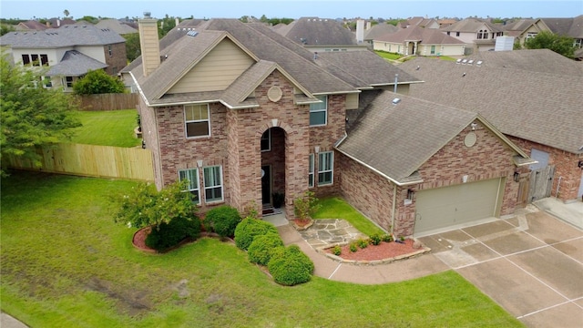 6105 Greenough Ct, Corpus Christi, TX 78414 - traditional-style home featuring brick siding, driveway, an attached garage, a residential view, and a shingled roof