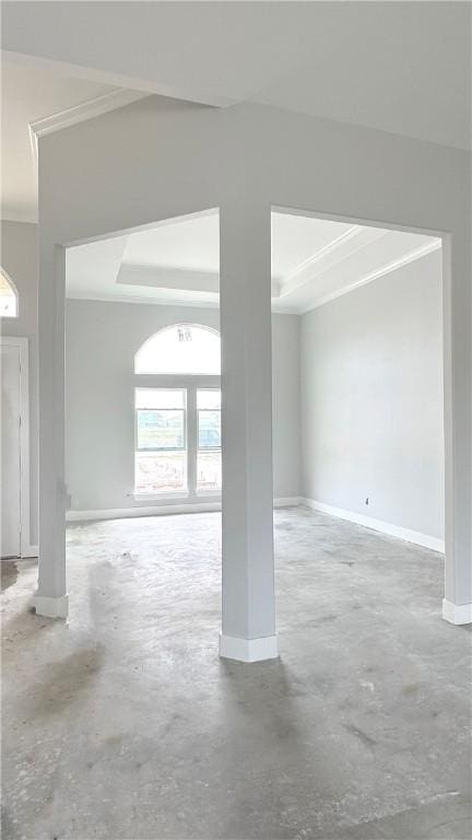 spare room featuring concrete flooring and ornamental molding