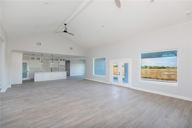 unfurnished living room with beamed ceiling, light hardwood / wood-style floors, high vaulted ceiling, and ceiling fan